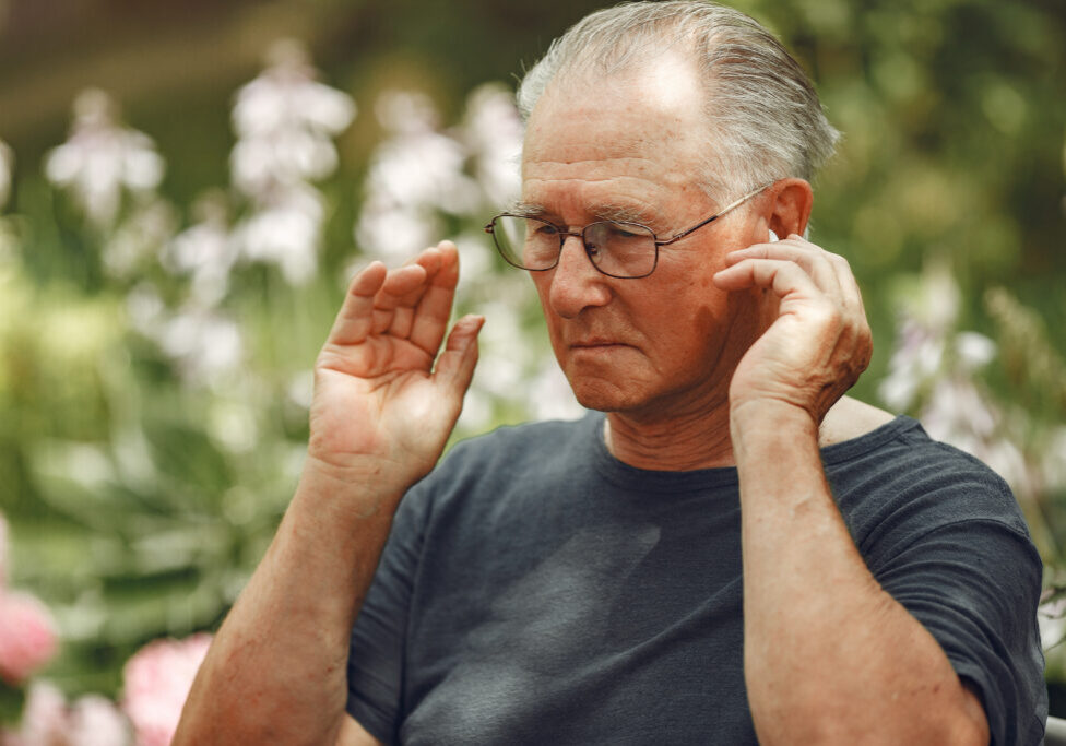 Technology, people and communication concept. Senior man at summer park. Grangfather using a phone.